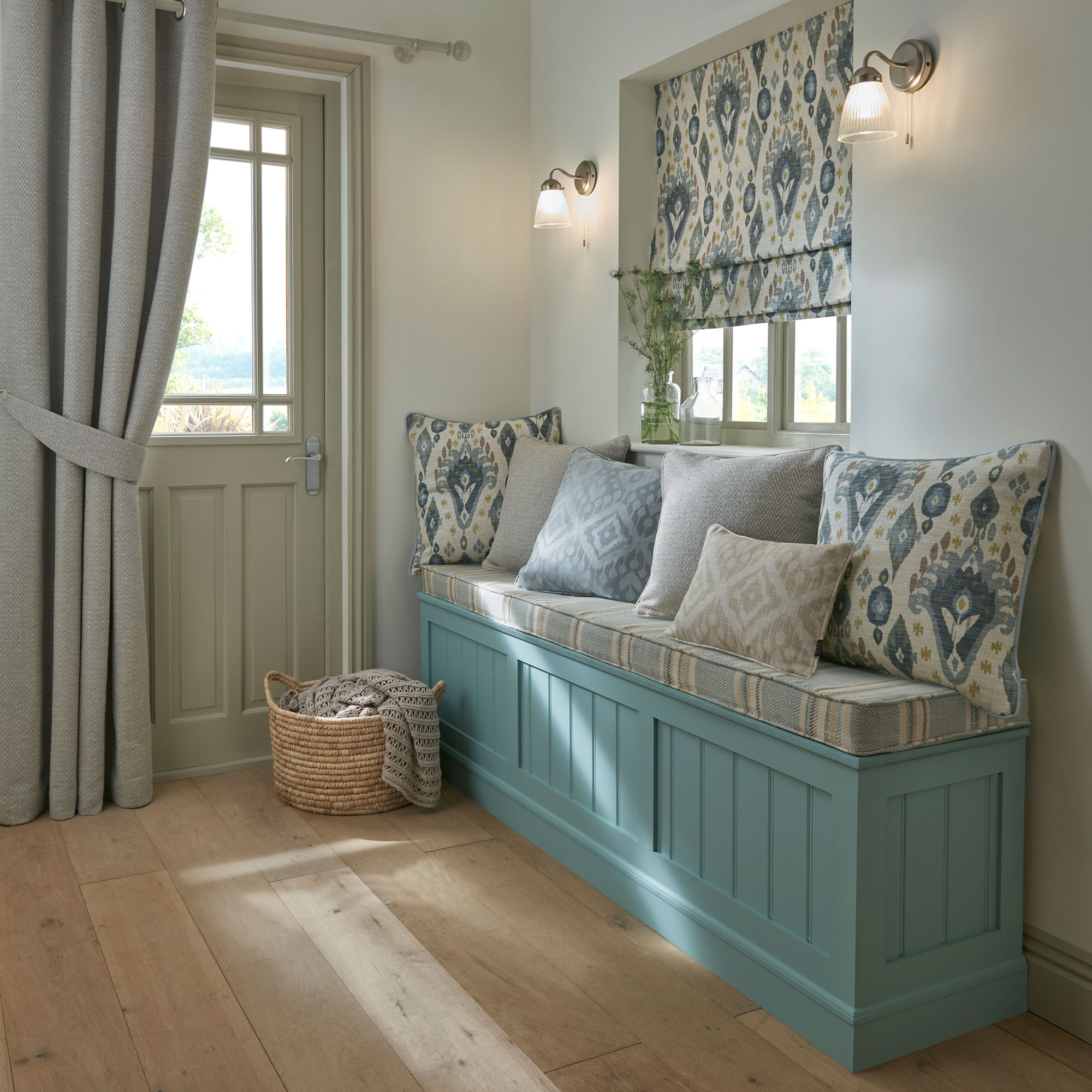 entrance hallway with blue upholstered storage bench and thick curtain over front door