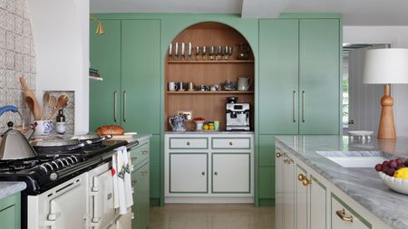 a kitchen with green full length cabinets and white perimeter cabinets with a green border