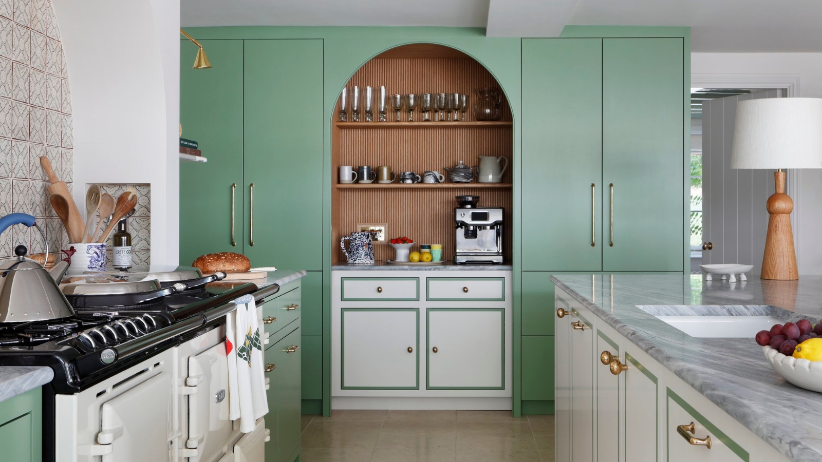 a kitchen with green full length cabinets and white perimeter cabinets with a green border