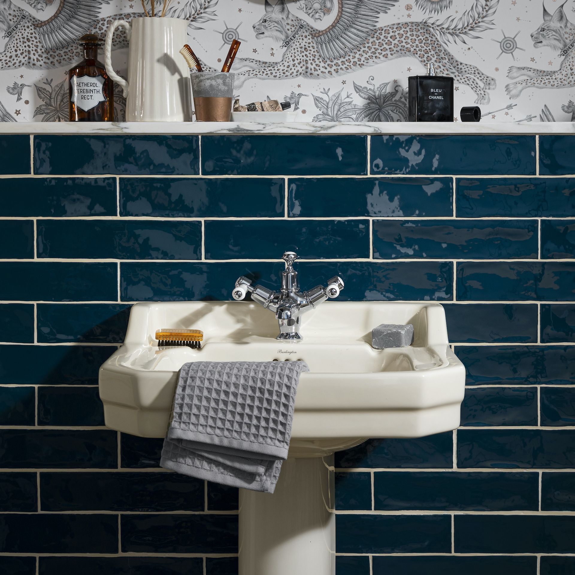 bathroom basin with dark blue metro tile backsplash
