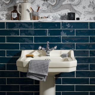 bathroom basin with dark blue metro tile backsplash