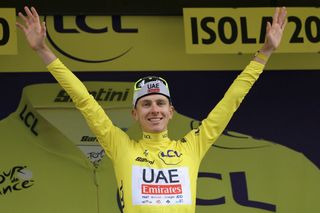 UAE Team Emirates team's Slovenian rider Tadej Pogacar celebrates on the podium with the overall leader's yellow jersey after the 19th stage of the 111th edition of the Tour de France cycling race, 144,6 km between Embrun and Isola 2000, in the French Alps, on July 19, 2024. (Photo by Thomas SAMSON / AFP) (Photo by THOMAS SAMSON/AFP via Getty Images)