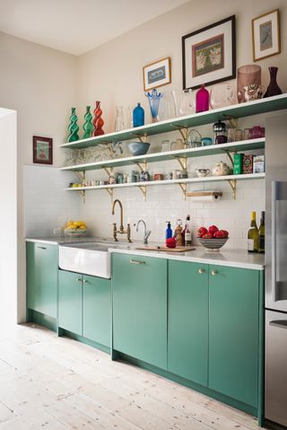 Small green kitchen with open shelving