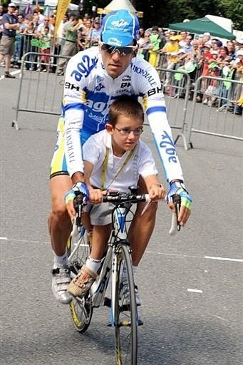 Jos&eacute; Luis Arrieta (AG2R La Mondiale) gives his son Igor a ride around the start village.