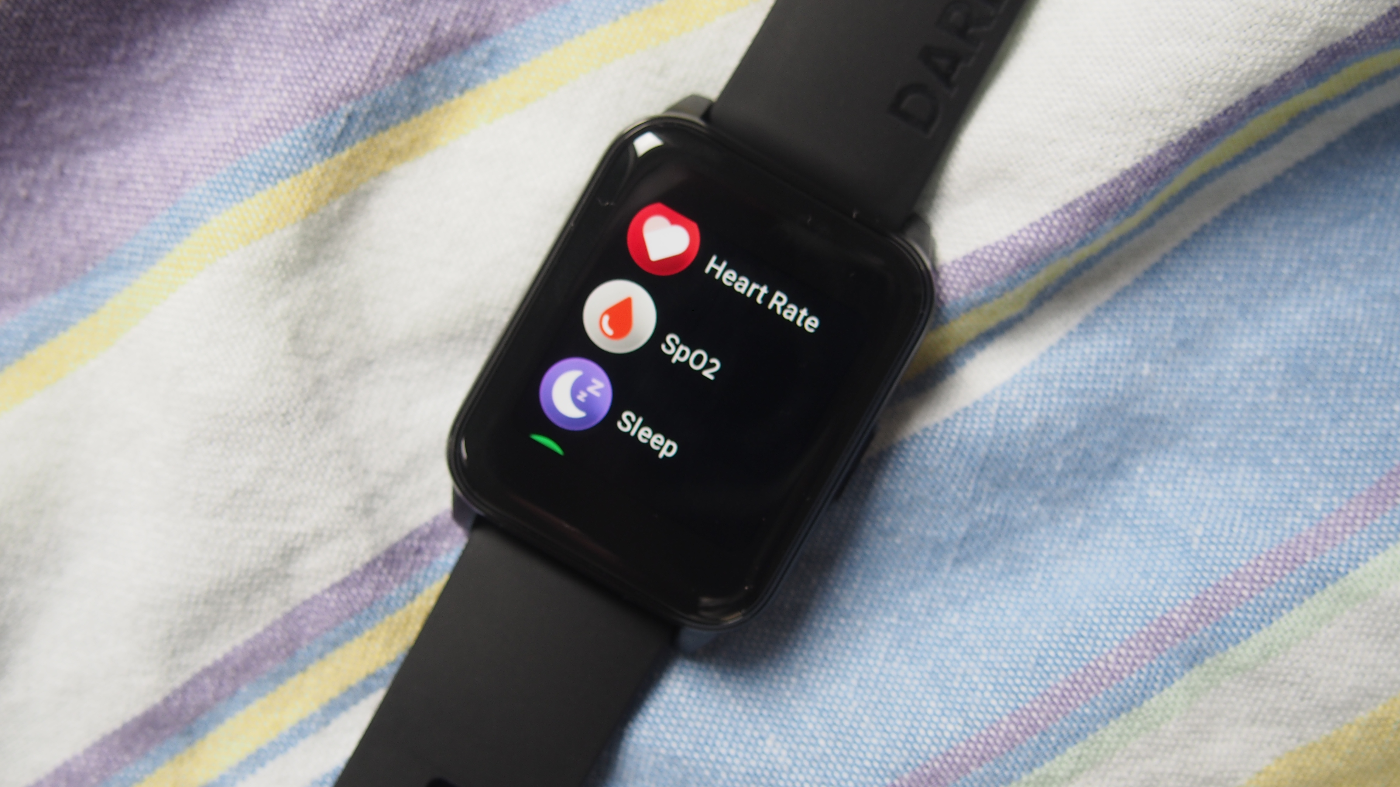 Close-up of Realme Watch 2 screen, showing heart rate, SpO2 and sleep app icons