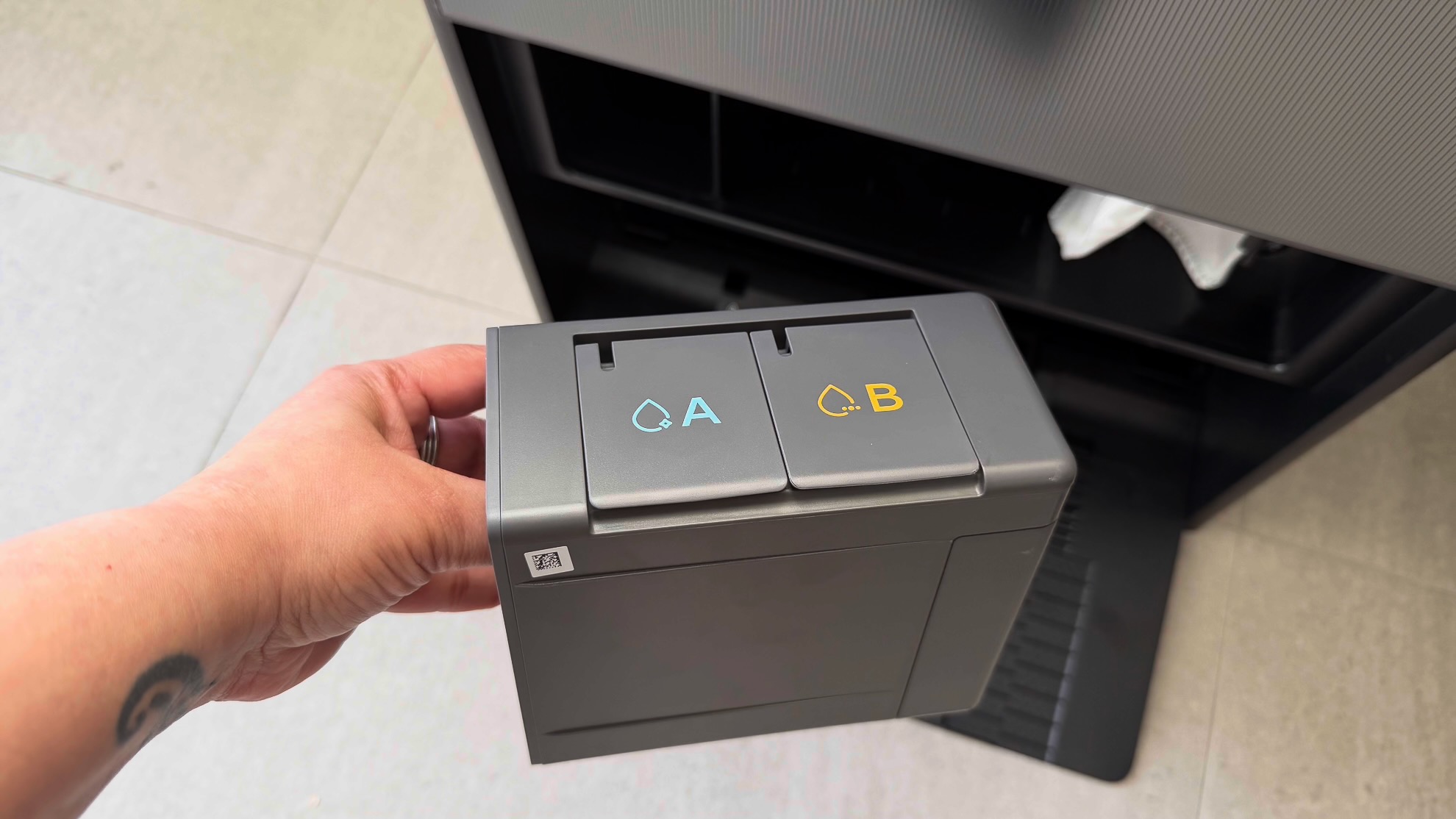 A personal holding the detergent dispenser of the Dreame Aqua10 Ultra 