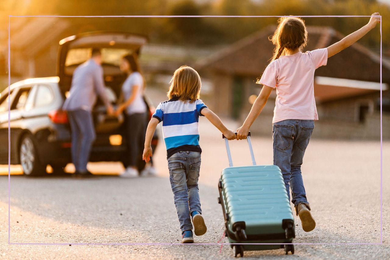 Family going on holiday, mum and dad at the car with kids pulling suitcase