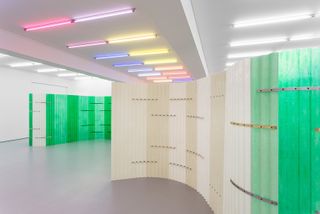 Neon ceiling lights in white room