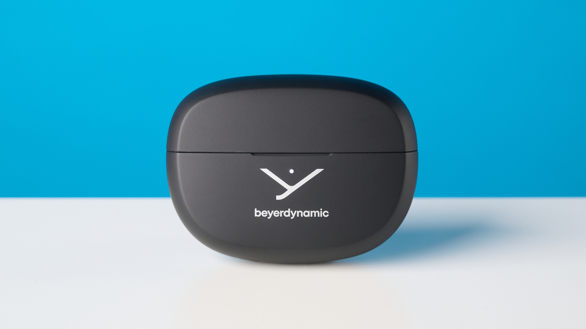 Beyerdynamic Amiron ZERO open-earbuds photographed on a blue background
