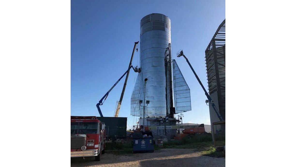 A photo tweeted by SpaceX founder and CEO Elon Musk on Sept. 22, 2019 shows technicians installing stability-controlling rear fins on Starship Mk1.