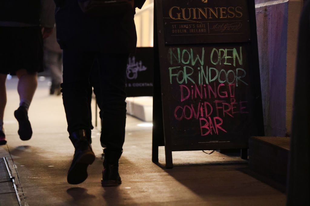 Bar in New York City with indoor dining sign.