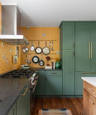 kitchen with green cabinets and yellow wall tiles