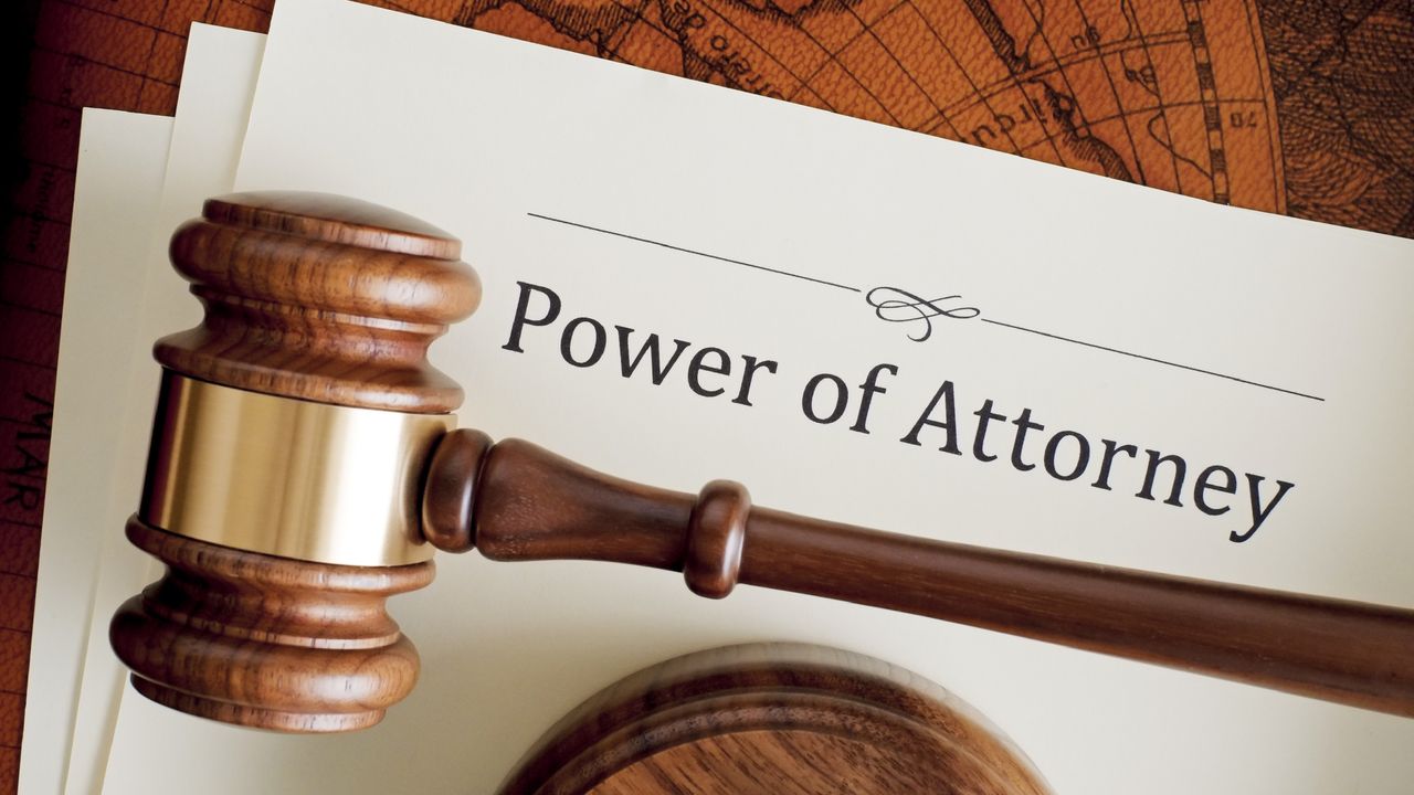 Power of attorney paperwork underneath a judge&#039;s gavel.