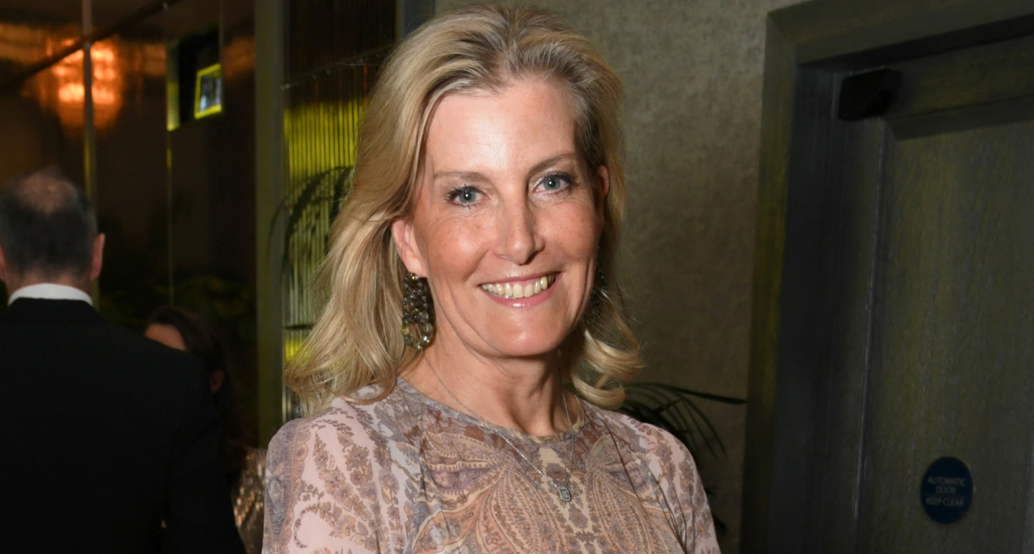 Duchess Sophie wearing a sheer blue paisley dress and smiling