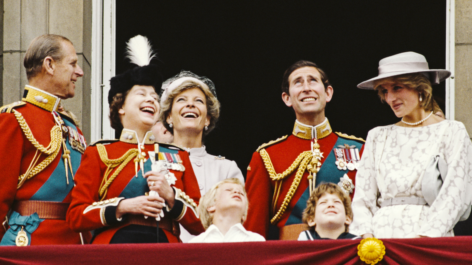 Princess Diana wears a white gown and matching hat on the Buckingham Palace balcony in 1983 for Trooping the Colour, alongside King Charles, Queen Elizabeth, Prince Philip, Princess Michael of Kent