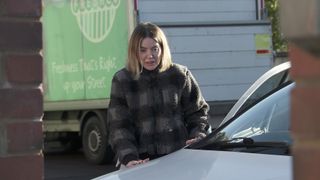 Abi gets out of the car, focused on her hallucination