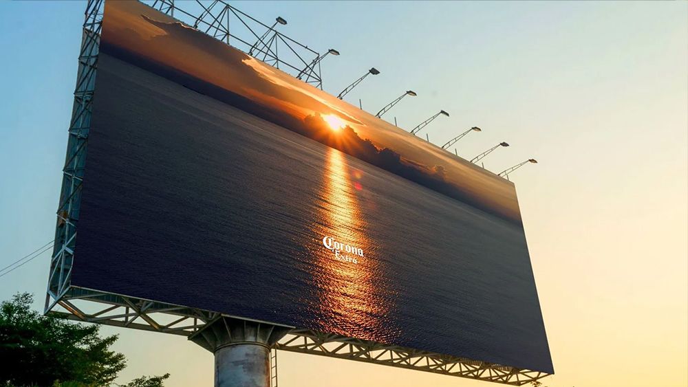 A Corona beer billboard advert showing an optical illusion in which the sunset looks like a beer bottle