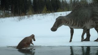 A juvenile Edmontosaurus climbing out of the water next to an adult Edmontosaurus in “Prehistoric Planet.”