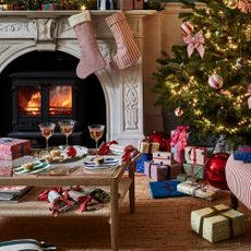 gifts under £100 christmas tree fireplace presents stripy armchair