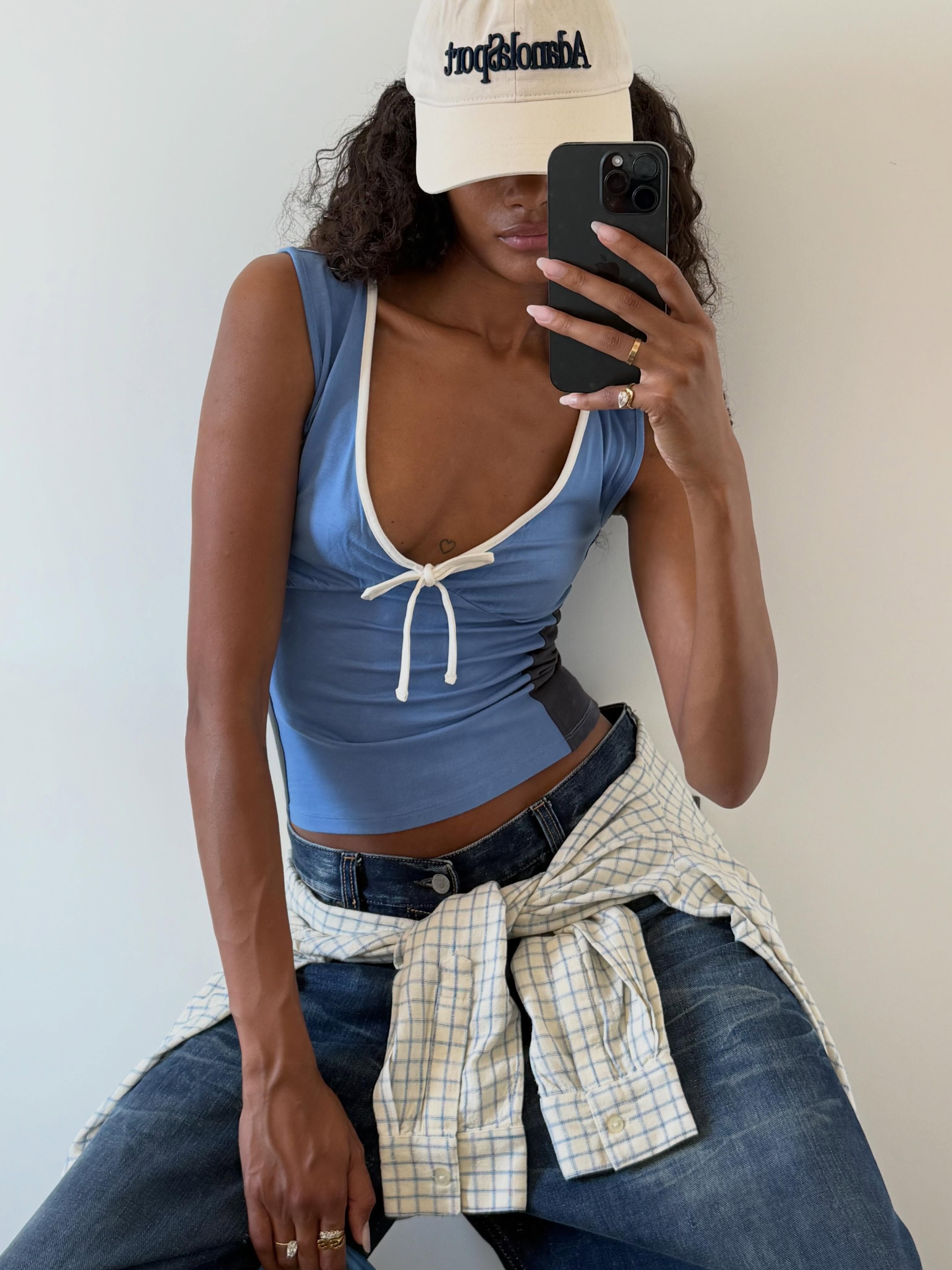 An image of a woman wearing summer to fall transitional denim outfit idea 2026