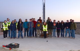 Student engineers with the New Mexico Tech Mechanical Engineering Design Clinic pose for a picture with their Mustang 6B sounding rocket ahead of a successful launch from Spaceport America in New Mexico on April 15, 2018.