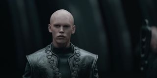 a character with no hair or eyebrows in black leather armor
