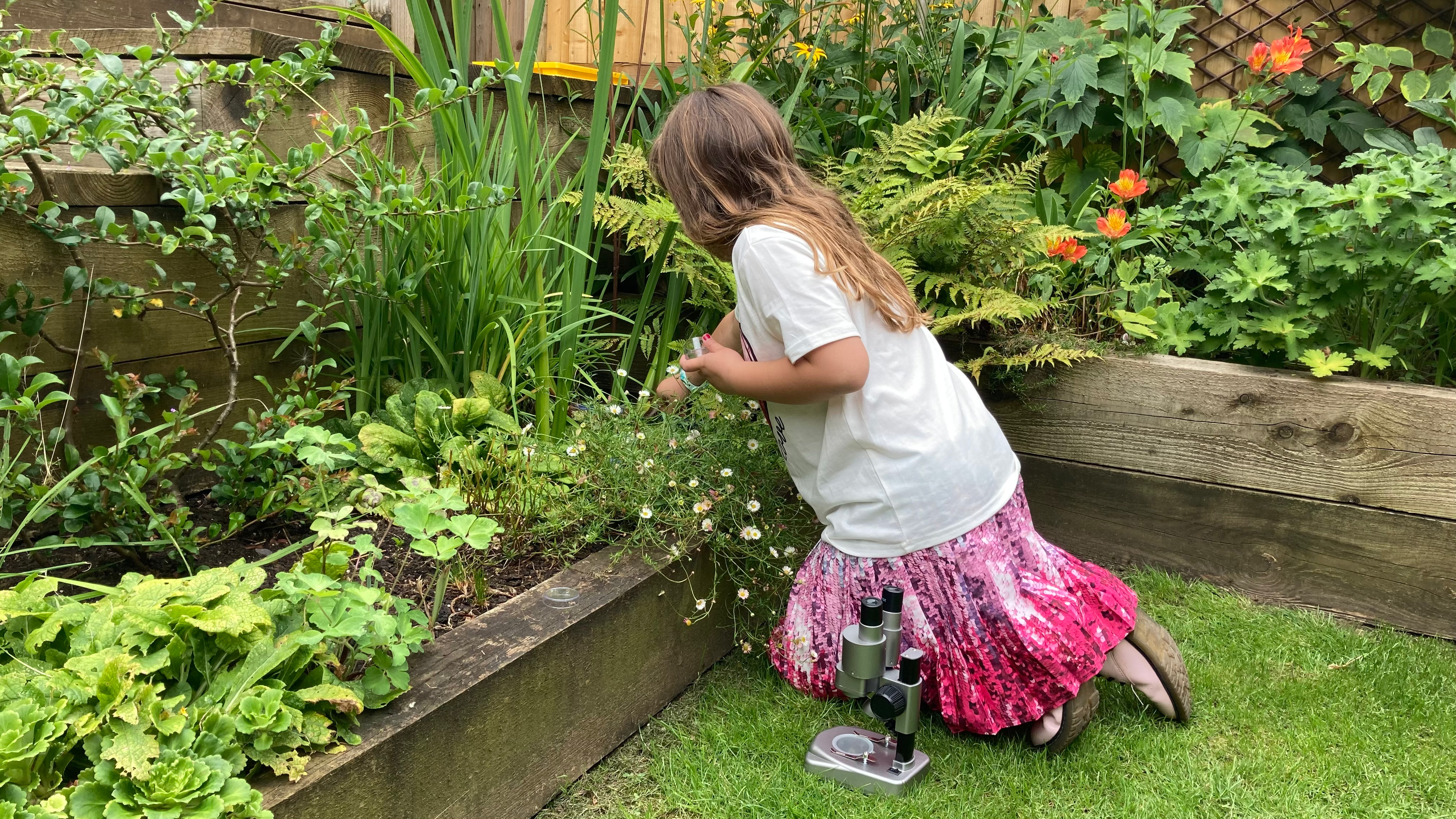 National Geographic Ultimate Dual Stereo Microscope being used by a child in a garden