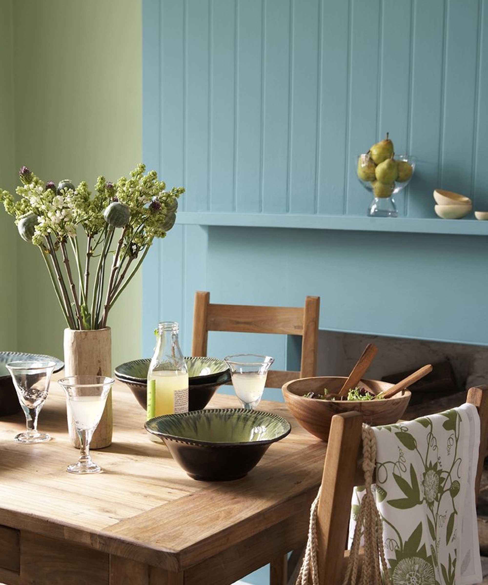 kitchen with wooden table and blue and green walls