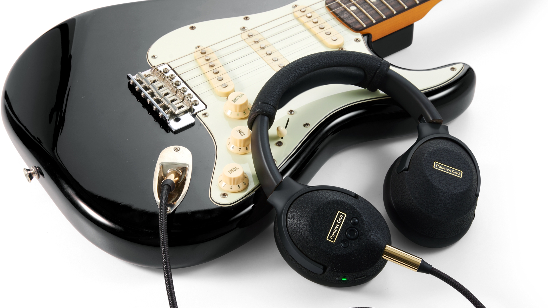 A pair of Positive Grid Spark Neo Core headphones on an electric guitar