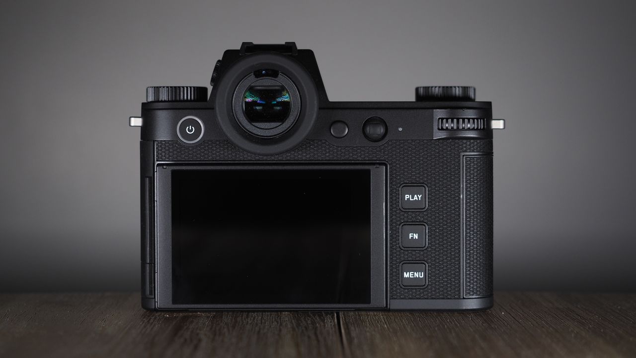 Leica SL3-S on a wooden surface with moody lighting