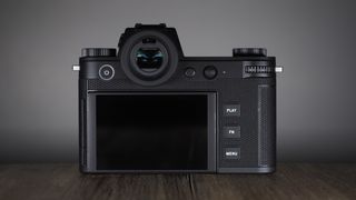 Leica SL3-S on a wooden surface with moody lighting