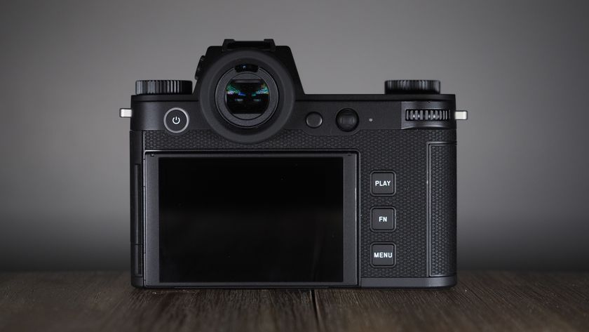 Leica SL3-S on a wooden surface with moody lighting