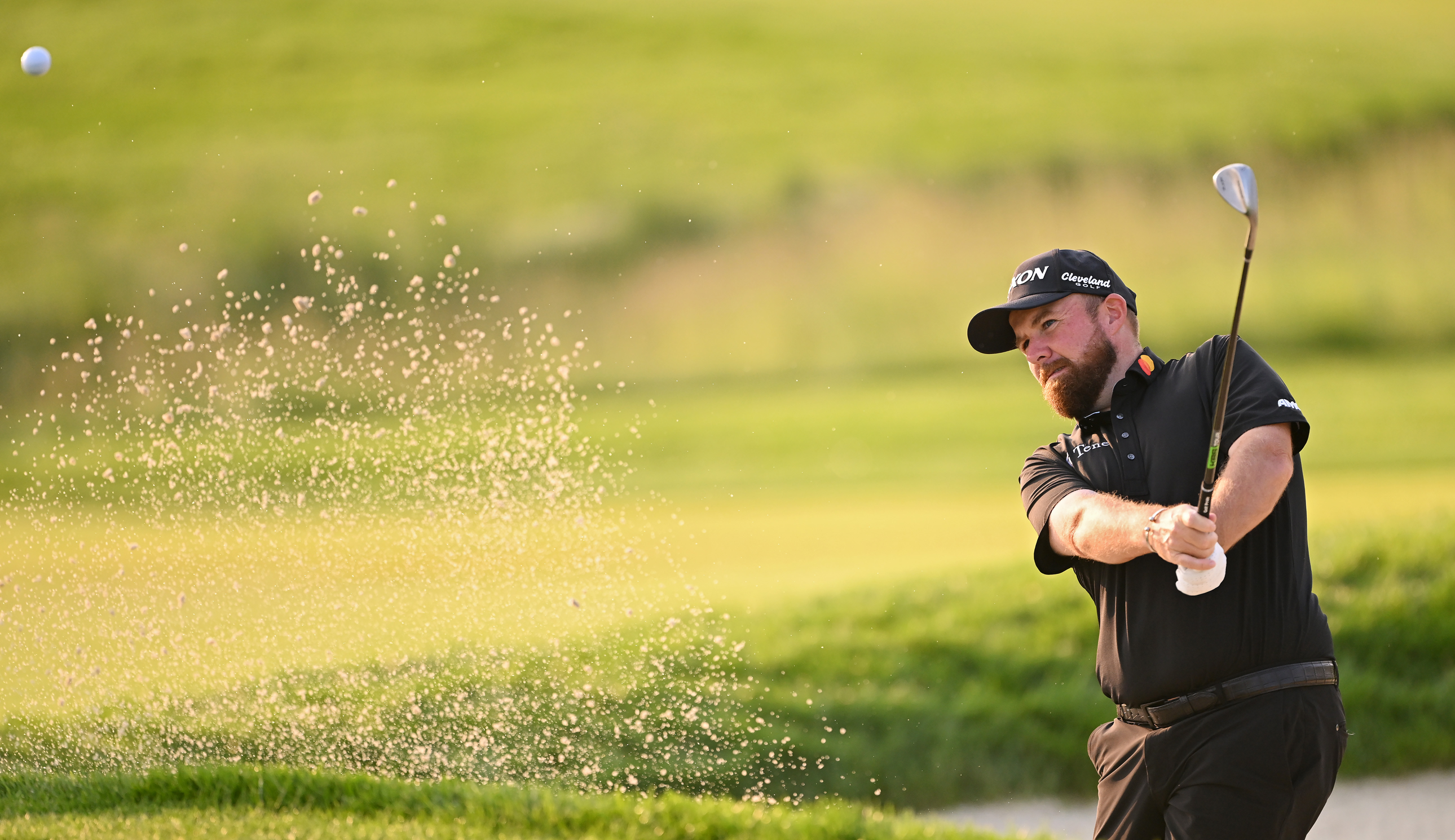 Shane Lowry plays a bunker shot at Oakmont Country Club