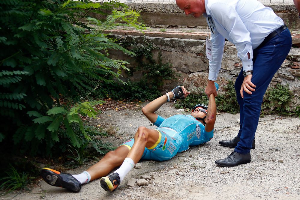 Diego Rosa (Astana) lies on the ground after crashing at Giro della Toscana