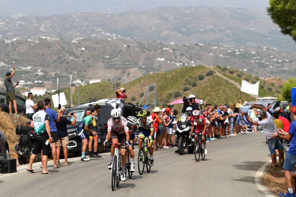 RINCON DE LA VICTORIA SPAIN AUGUST 24 LR Geoffrey Bouchard of France and AG2R Citren Team Kenny Elissonde of France and Team Trek Segafredo and Odd Christian Eiking of Norway Team Intermarch Wanty Gobert Matriaux and Guillaume Martin of France and Team Cofidis in the Breakaway while fans cheer during the 76th Tour of Spain 2021 Stage 10 a 189km stage from Roquetas de Mar to Rincn de la Victoria lavuelta LaVuelta21 on August 24 2021 in Rincon De La Victoria Spain Photo by Tim de WaeleGetty Images
