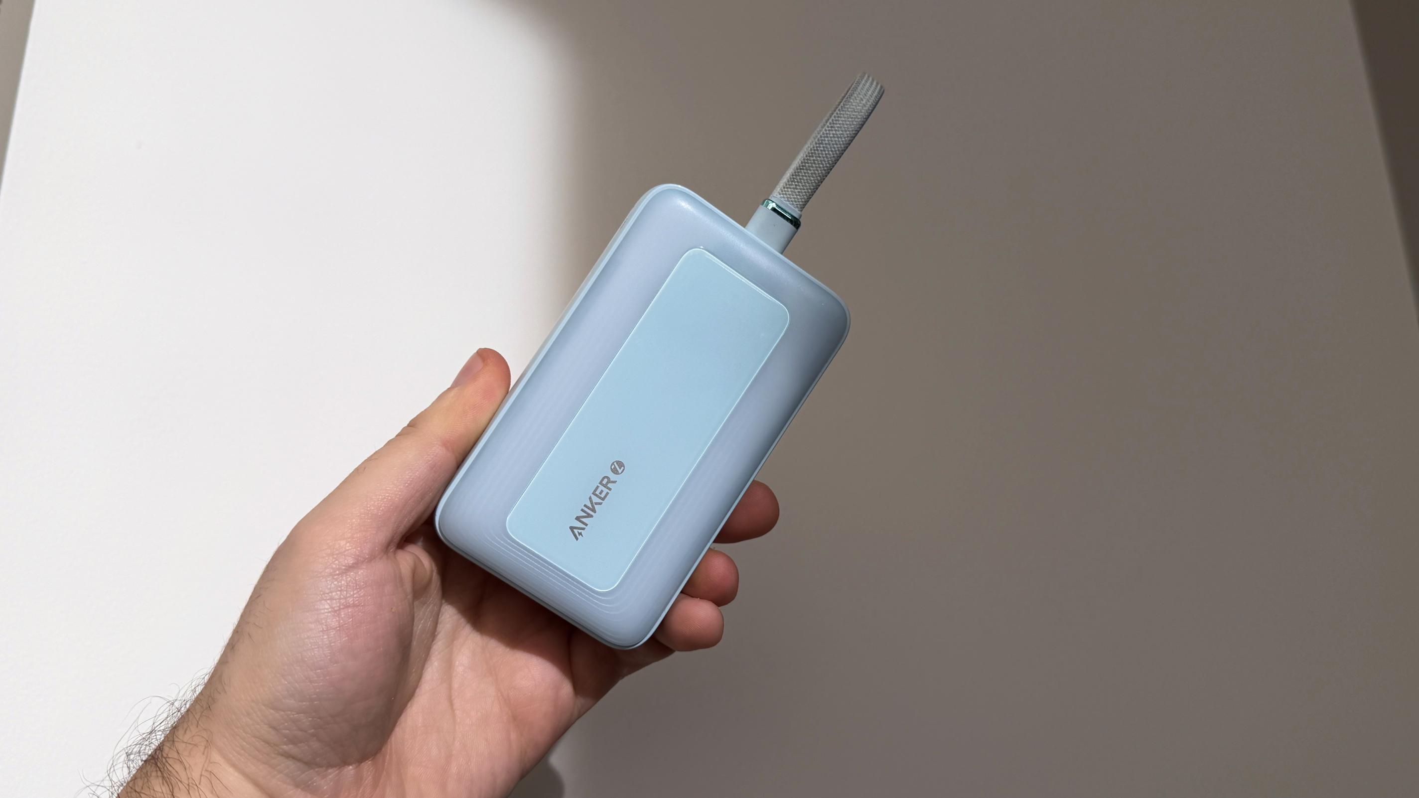 Anker Battery Pack in hand, 10,000mAh blue