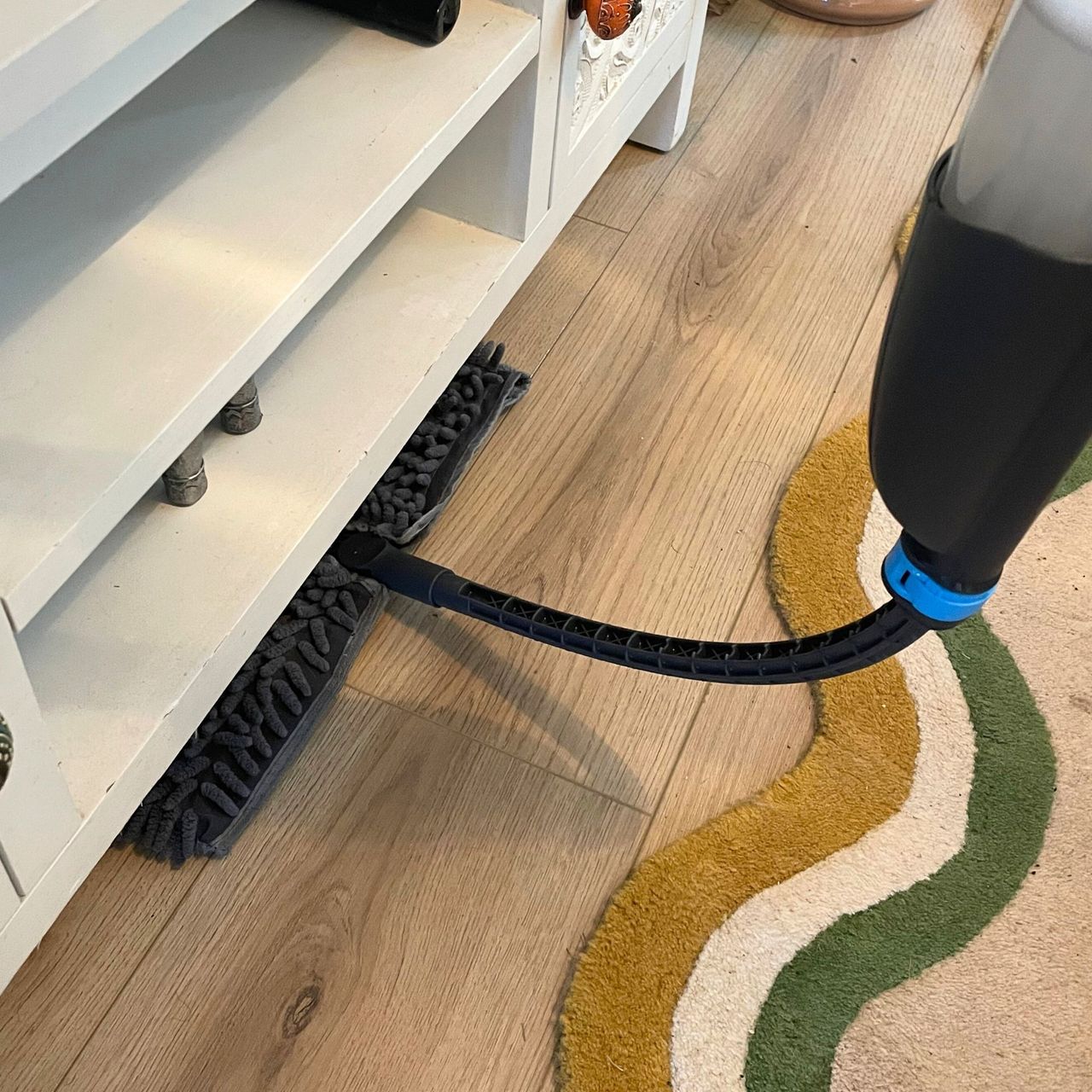Minky Flexi Spray Mop cleaning under white unit