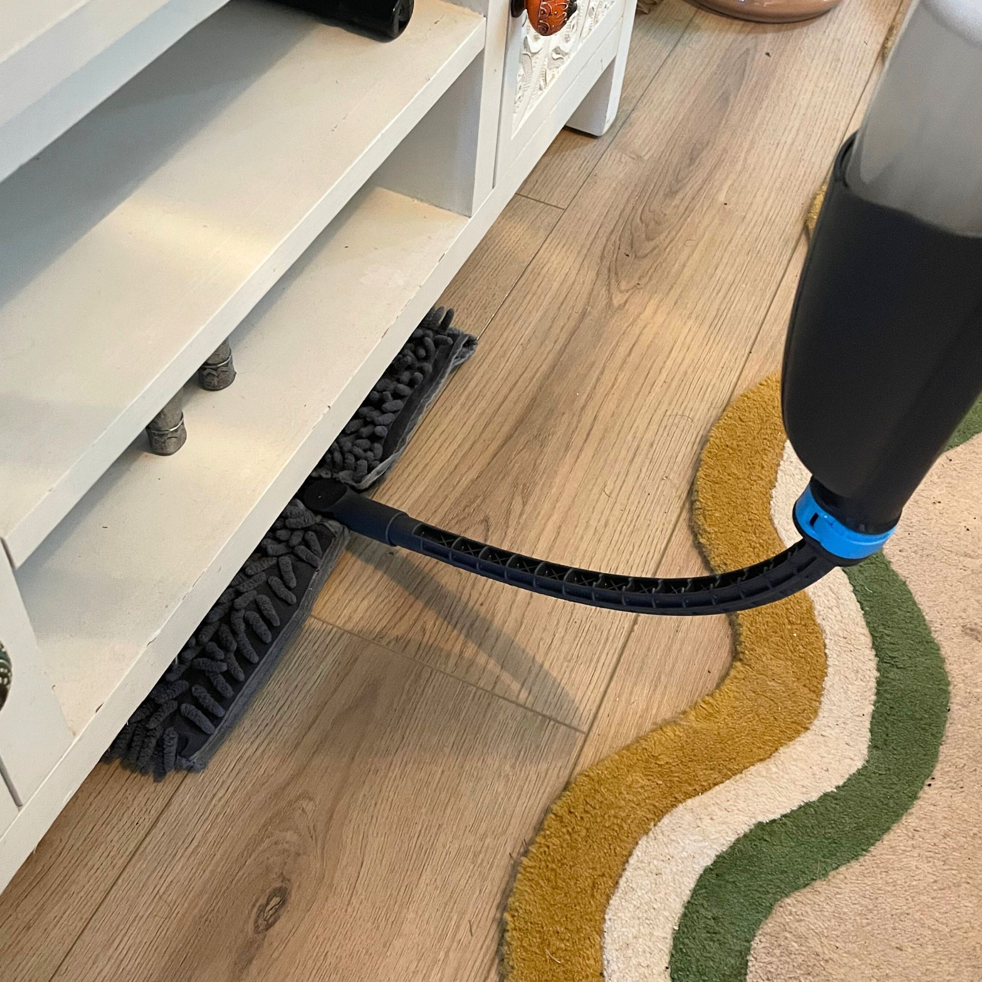 Minky Flexi Spray Mop cleaning under white unit