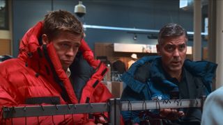 Brad Pitt and George Clooney look up with curiosity while wearing winter coats in Ocean&#039;s Thirteen.