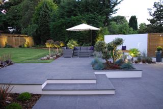 modern garden with dark paving and garden steps