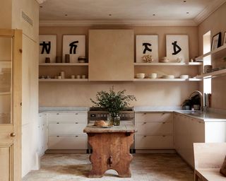 French country kitchen with open shelving and art