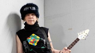 Michael Schenker holding a Flying V guitar