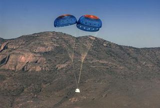 Blue Origin's New Shepherd spacecraft landing with parachutes.
