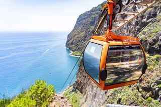 A cable car descends into Camara de Lobos in Madeira