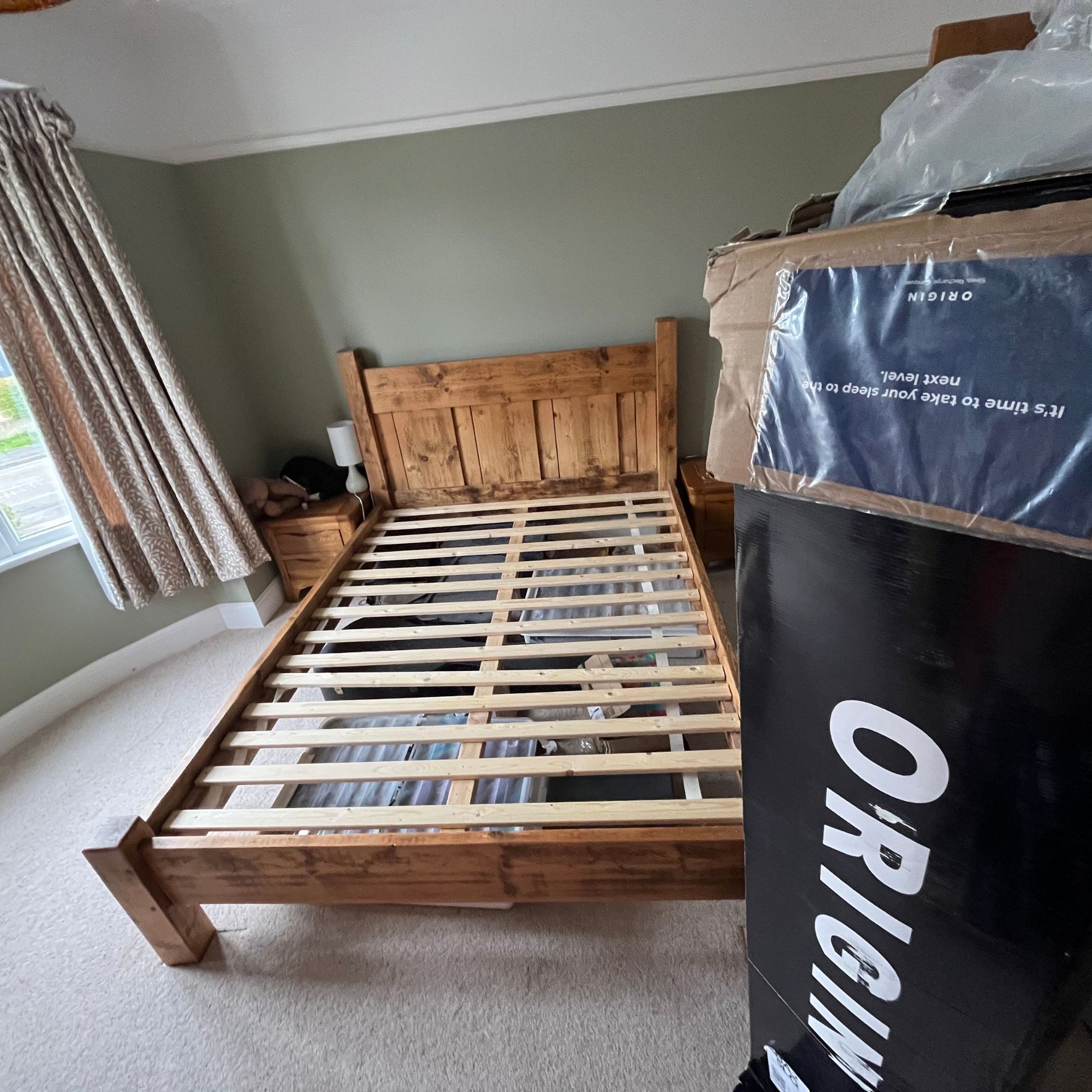 Origin LumbarCloud mattress in box next to bed frame