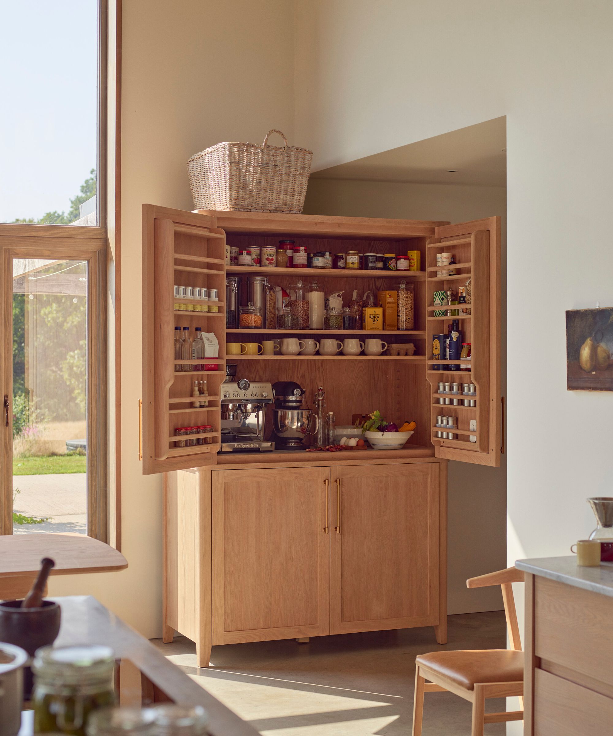 A large kitchen with a freestanding wood pantry cabinet