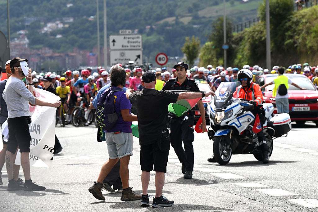 BILBAO, SPAIN - SEPTEMBER 03: A group of fans protest against Team Israel - Premier Tech riders by displaying Palestinian flags and stop the peloton prior to the La Vuelta - 80th Tour of Spain 2025, Stage 11 a 157.4km stage from Bilbao to Bilbao / #UCIWT / on September 03, 2025 in Bilbao, Spain. (Photo by Dario Belingheri/Getty Images)