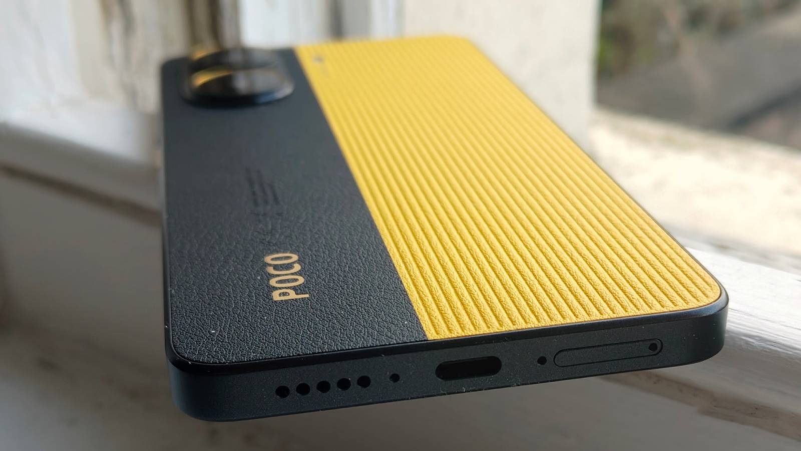 The Xiaomi Poco X7 Pro on a window sill.