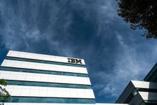 An IBM building as seen against a dark blue, cloudy sky
