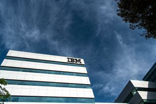 An IBM building as seen against a dark blue, cloudy sky
